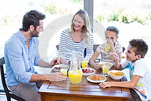 Happy family having breakfast together