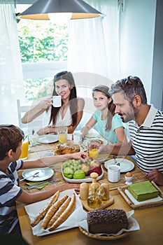 Happy family having breakfast together