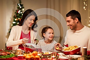 Happy family having christmas dinner at home