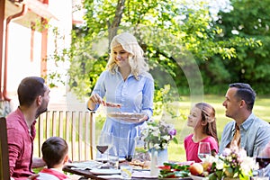 Happy family having dinner or summer garden party