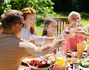 Happy family having dinner or summer garden party