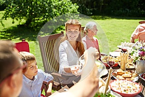 Happy family having dinner or summer garden party