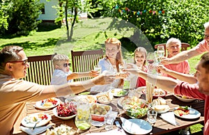 Happy family having dinner or summer garden party