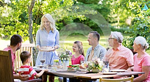 Happy family having dinner or summer garden party