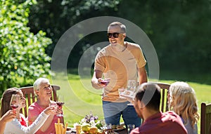 Happy family having dinner or summer garden party