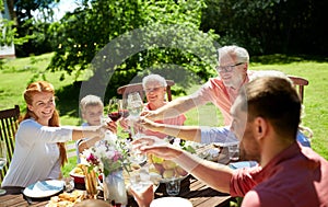 Happy family having dinner or summer garden party