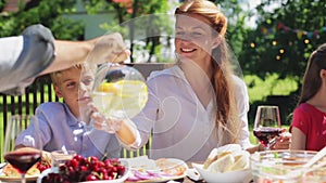 Happy family having dinner or summer garden party