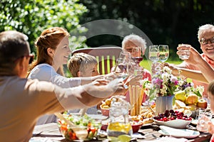 Happy family having dinner or summer garden party