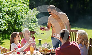 Happy family having dinner or summer garden party