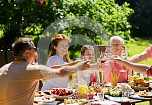 Happy family having dinner or summer garden party