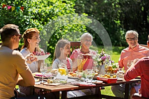 Happy family having dinner or summer garden party