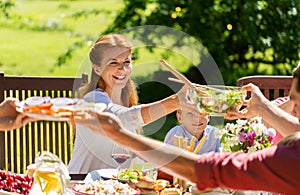 Happy family having dinner or summer garden party