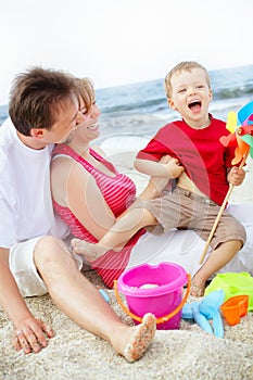 Happy family having fun on the beach.