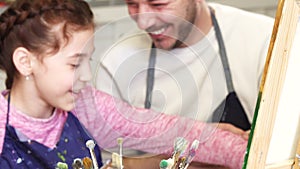 Happy family having fun drawing at the art studio together