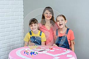 Happy family having fun laughing while playing board games at a table