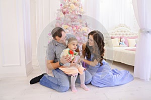 Happy family having fun and laughing together in spacious bedroo