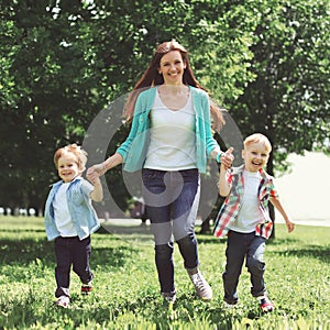 Happy family is having fun, mother and two children sons playing