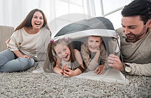 Happy family having fun in a new apartment