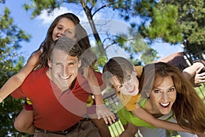 Happy Family Having Fun Outside In Park