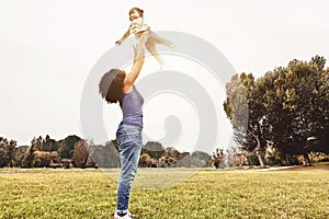 Happy family having fun in park outdoor - Mother and daughter enjoying good time playing together outside