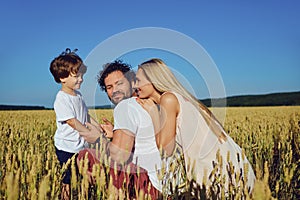 Happy family having fun playing in the field.