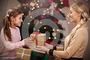 Happy family having fun with presents during Christmas time