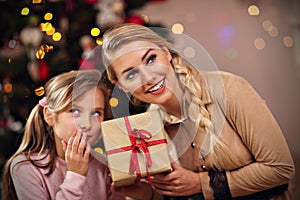 Happy family having fun with presents during Christmas time