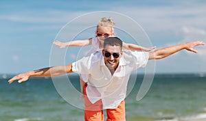 Happy family having fun on summer beach