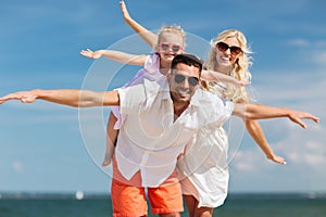Happy family having fun on summer beach