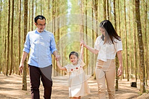 Happy family having fun with summer trip in park together on weekend