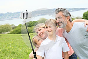 Happy family having fun taking selfie outdoors