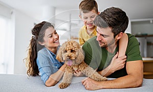 Happy family having fun time, playing together at home with dog