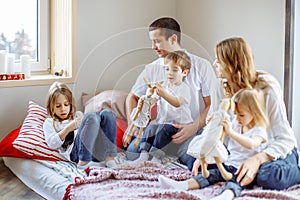 Happy family having fun together at home in bedroom.