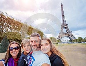 Happy family having fun together in Paris near the Eiffel tower