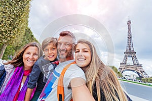 Happy family having fun together in Paris near the Eiffel tower