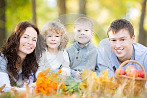 Happy family having picnic in autumn park