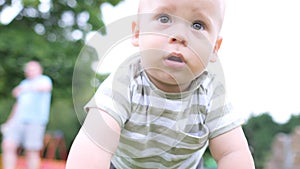 Happy family having picnic. Little Baby is crawling on green grass. Summer in park. Siblings children Playing in green