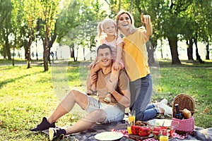 Happy family having picnic in park