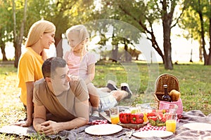 Happy family having picnic in park