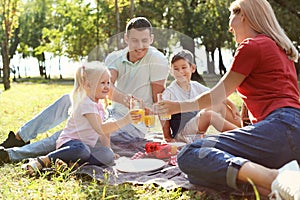 Happy family having picnic in park