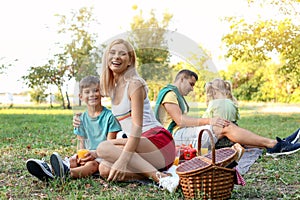 Happy family having picnic in park