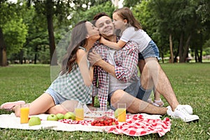 Happy family having picnic in park