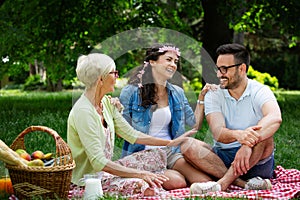 Happy family having picnic in park outdoors