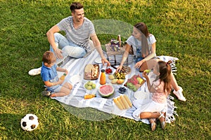 Happy family having picnic in park on summer day