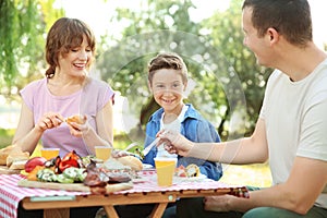 Happy family having picnic on summer day