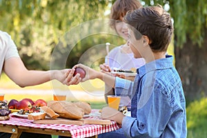 Happy family having picnic on summer day