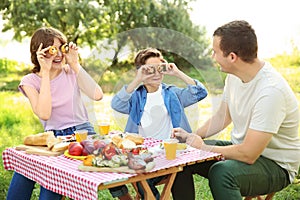 Happy family having picnic on summer day