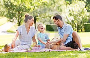 Happy family having picnic at summer park