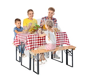 Happy family having picnic at table