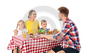 Happy family having picnic at table on  background